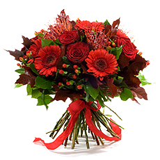 This sophisticated bouquet enlivens your house with the contrast of glorious winter colors : germini, nutan, burgundy red roses, hypericum berries, ...