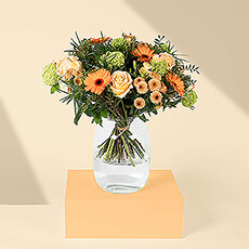 Brighten any room and lift up someone's spirits with this beautiful fresh orange bouquet. Cheerful orange gerbera daisies, soft orange mums, and beautiful roses are complemented by pops of green in the lovely flower arrangement. The vibrant bouquet is created by hand by our own in-house florists.