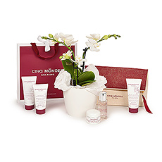 A charming gift bag with Cinq Mondes luxury French beauty products is presented with a luxurious mini orchid in this elegant gift set.