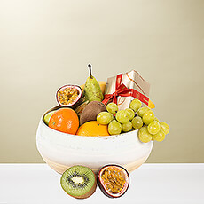 There is nothing more delicious than the perfect pairing of fresh, juicy fruit with rich Belgian chocolate. Enjoy classic and exotic fruit bursting with flavor and scrumptious Leondias chocolates in this appealing fruit gift. We hand pack everything in a beautiful, reusable natural bamboo bowl for a lovely presentation.