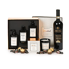 A luxurious gift box with a divine smelling scented candle and gift box with body care products from Atelier Rebul, a bottle of Amarone Valpolicella wine and delicious chocolates.