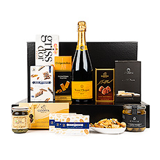 Make a statement of elegance with this prestigious Veuve Clicquot Champagne and gourmet gift hamper. The Veuve Clicquot Brut is composed of 62% pinot noir, 8% pinot meunier, and 30% chardonnay. A classic and desirable Champagne to savor and share, enjoy its lively and persistent sparkle with our impressive collection of European fine foods.