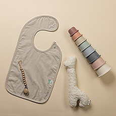 Treat baby to the best European design in this cozy set of baby essentials! 

Playtime will be fun and safe with the organic cotton giraffe rattle by Belgian company Trixie and a set of classic stacking cups (free of BPA and phthalates) by Mushie of Denmark. A soft, organic cotton bib and pacifier clip in peaceful grey complete the gift.
