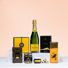 This Champagne and snacks gift is a real treat! Discover the perfect pairing of iconic Veuve Clicquot Brut Champagne with Belgian chocolates and gourmet savory snacks.
