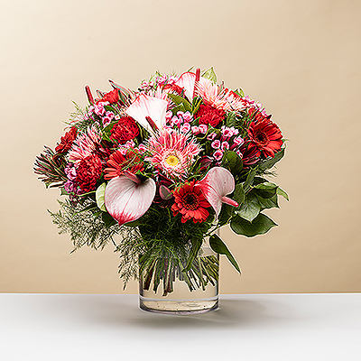 Surprise someone special with a stunning bouquet of pink and red flowers in an original composition.