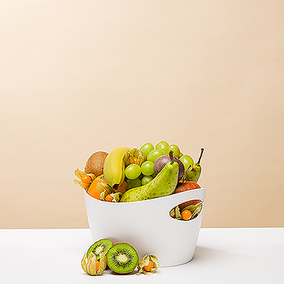 Send the gift of health! This delicious fresh fruit assortment features handpicked seasonal fruit for the most juicy, nutritious flavors of the season. The fruit is hand packed with care in a reusable small Koziol Bottichelli tub that will find endless uses after the fruit has been enjoyed.
