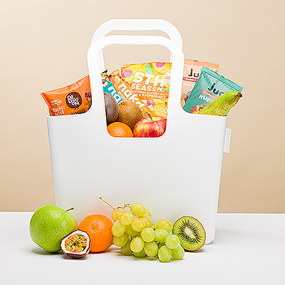 Treat someone to a reusable Koziol 'Taschelino' tote filled with the best selection of juicy, fresh fruit and healthy snacks. The collection of handpicked seasonal fruit, crunchy nuts, Nakd snack bars, and a Blooom organic energy ball makes a great birthday gift idea, office gift, thank you gift, or tasty surprise for any occasion.