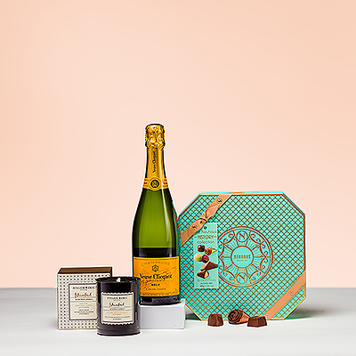 Deleita todos los sentidos con la combinación perfecta del emblemático champán Veuve Clicquot, una lujosa vela Atelier Rebul Istanbul y los deliciosos bombones belgas Neuhaus. Este exquisito trío de lujos es el regalo ideal para todo bon vivant. 

La vela perfumada de lujo Atelier Rebul Estambul te invita a un viaje con los exóticos aromas de Turquía, con una bergamota de ensueño y cálidos tonos de canela, azafrán y clavo. Acentos florales de violeta, jazmín y orquídea negra se unen a la vainilla, el ámbar, el almizcle, el cedro, el pachulí y el sándalo para una inmersión total en el lujo y el placer.

El mundialmente famoso Veuve Clicquot es un prestigioso Champagne sin añada con una mezcla de tres uvas: Pinot Noir, Pinot Meunier y Chardonnay. Este codiciado Champagne es apreciado por su deliciosa combinación de frescura y potencia con burbujas finas y duraderas y un aroma delicado y afrutado.

La caja Neuhaus History Collection ofrece 28 deliciosas obras maestras de chocolate y un folleto que explica la rica historia de este maître chocolatero belga. El extraordinario surtido ofrece una exquisita selección de los mejores pralinés belgas con chocolate puro, con leche y blanco y diversos y sabrosos rellenos.