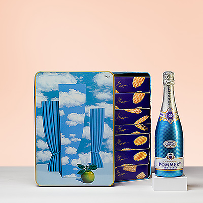 ¡Abre la burbuja y disfruta de la vida! La moderna experiencia del champán Pommery Royal Blue Sky Sur Glace se combina con una lata de recuerdo de Jules Destrooper Magritte y una cajita de cuatro bombones Godiva perfectos.