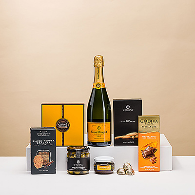 This Champagne and snacks gift is a real treat! Discover the perfect pairing of iconic Veuve Clicquot Brut Champagne with Belgian chocolates and gourmet savory snacks.