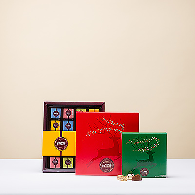 Felicíteles la Navidad con una torre de delicioso chocolate Corné Port-Royal. Este año, las cajas regalo de Navidad Corné Port-Royal están decoradas con un reno saltarín y luces de colores.