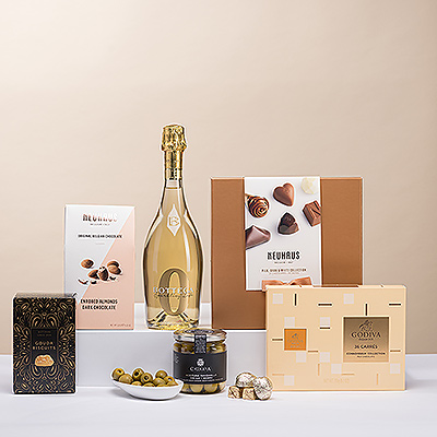 Presenting the ultimate collection of European savory snacks and Belgian chocolates. A festive bottle of Bottega Zero White non-alcoholic sparkling wine accompanies the gourmet foods.