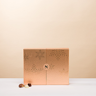 Presenting the most exquisite gift box of Neuhaus Christmas chocolates to give and to share. The 2023 Neuhaus Winter Premium Box is a shimmering bronze gift box that slides open to reveal 62 delectable Belgian chocolates.