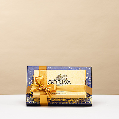 Two iconic Godiva chocolate boxes beautifully wrapped together in a festive tower — a luxurious holiday gift that combines timeless Belgian craftsmanship with the warmth of the season.