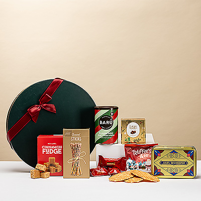 A festive Cozy Holiday Hot Chocolate, Tea & Sweets Gift Box filled with Barú peppermint hot chocolate, Belgian chocolates, caramel sweets, Jules biscuits, and luxurious Mathez truffles — the perfect gift for a warm and cozy Christmas night.