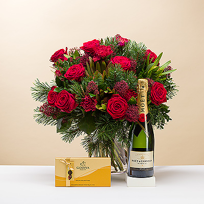 Make it a very Merry Christmas with a large beautiful red and green bouquet presented with elegant Moët & Chandon Champagne and 8 iconic Godiva chocolates. Classic red roses and other blossoms are complemented with sprigs of pine and greenery in this festive Christmas flower arrangement, created with care by our in-house florists.