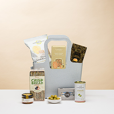 What could be better than sharing a gourmet picnic on a sunny afternoon? This unique gourmet gift features a delicious collection of European savory snacks and appetizers hand packed in a reusable take-anywhere Koziol tote.