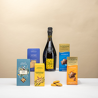 Celebrate in style with Veuve Clicquot La Grande Dame and a curated selection of gourmet delights, including cheese shortbreads, aged Gouda crisps, roasted Guara almonds, and Godiva milk chocolate.