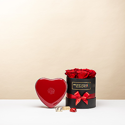 Surprise them with the ultimate blend of romance and luxury. This elegant black box features real preserved red roses that last for years, paired with a heart-shaped box of exquisite Corné Port-Royal Belgian pralines. The perfect gift to make someone feel truly special.